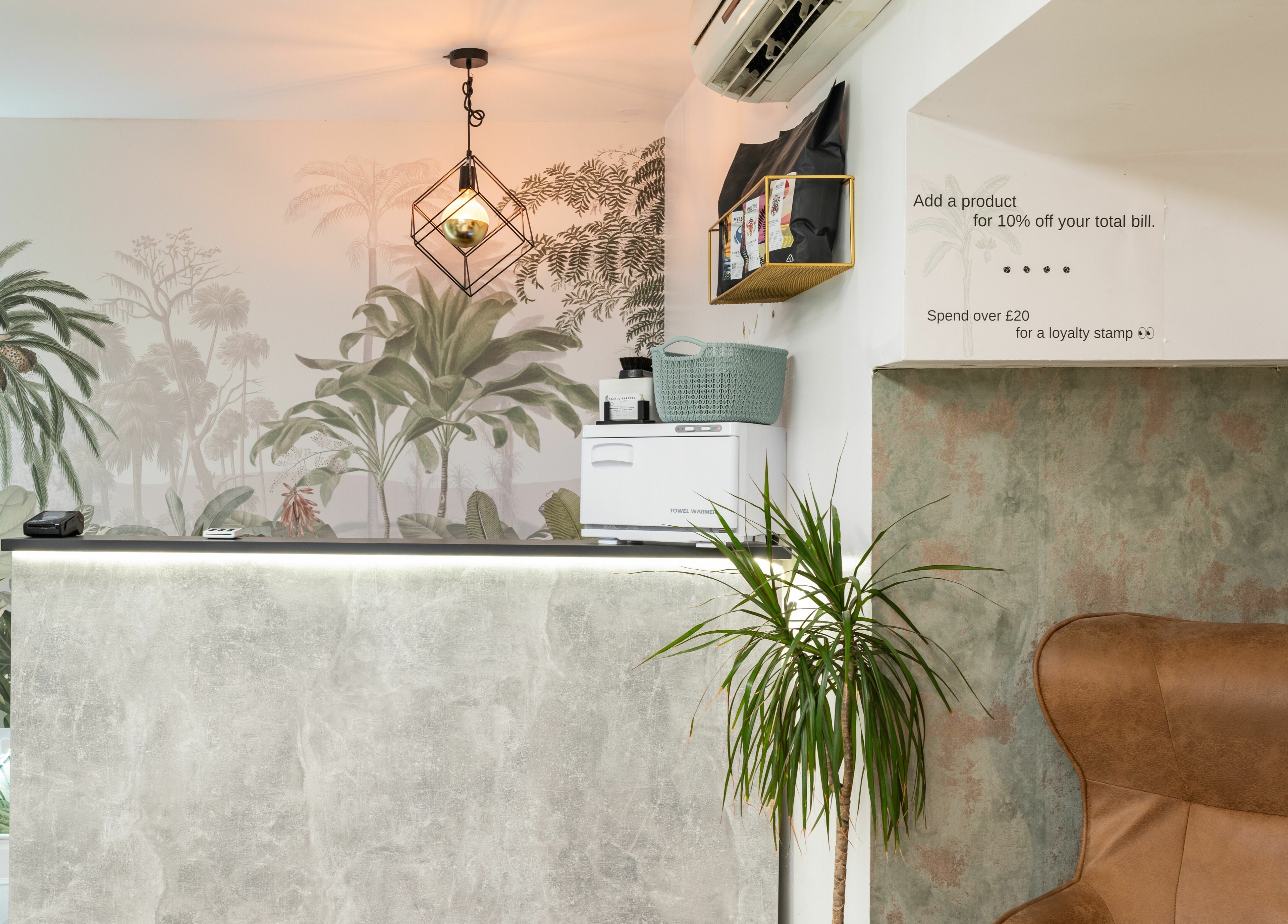 Reception of Saints Barbers Crouch End, London, England, GB with tropical themed decor and modern design.