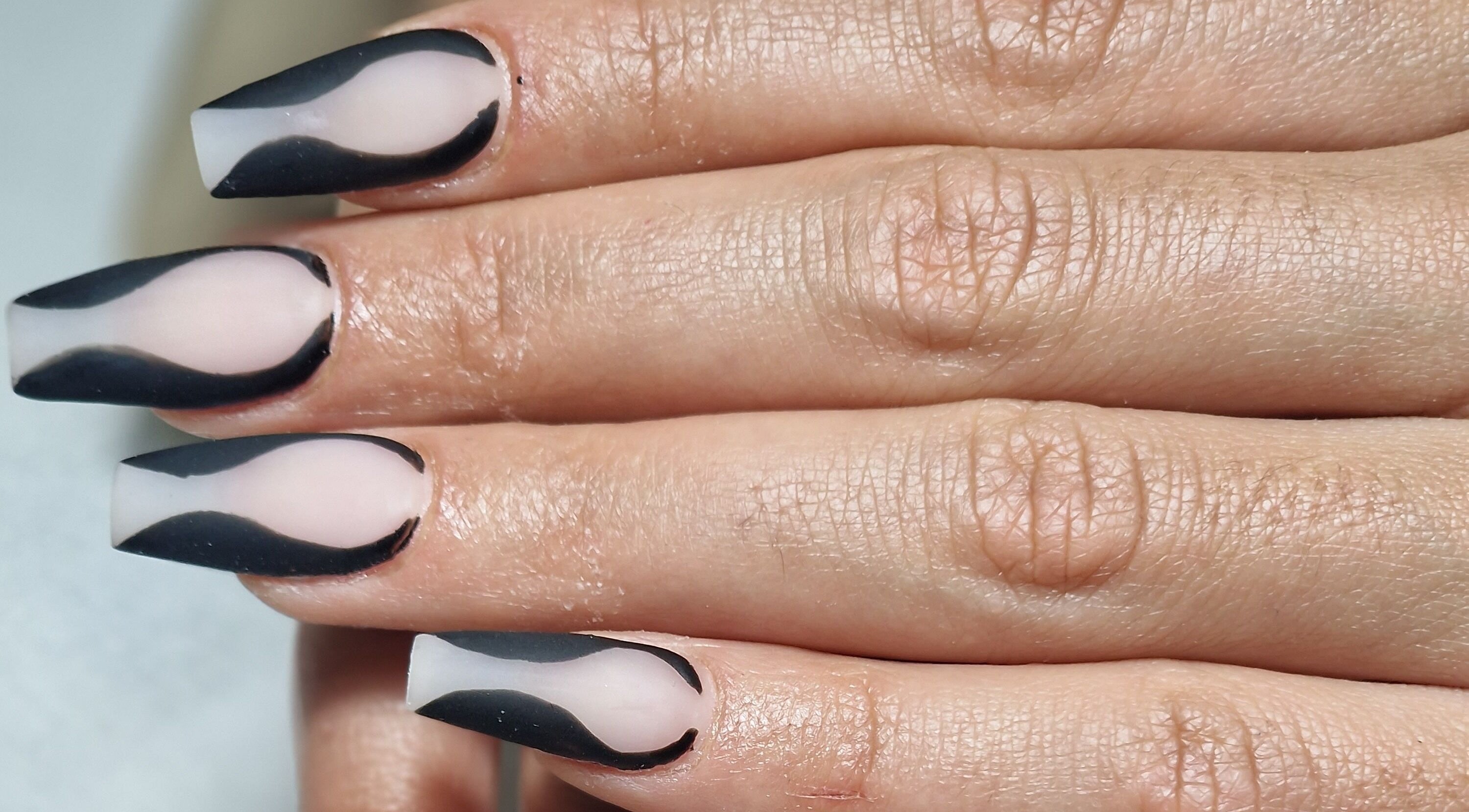 Stylish black and nude wavy nail art at Body Boutique in Watford, England, GB.