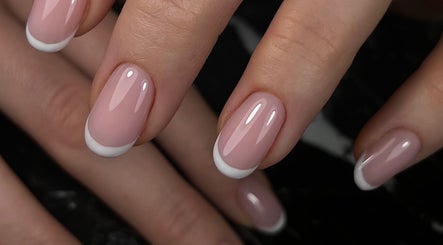 Elegant French manicure at Gelvibes, Montréal, Québec, CA, showcasing glossy pink nails with white tips.