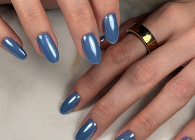 Elegant blue manicure at Gelvibes, Montréal, Québec, CA showcasing chic nail art.