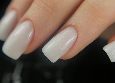 Close-up of glossy white nails at Gelvibes, Montréal, Québec, CA.