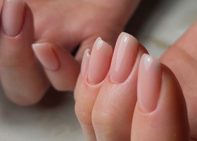 Elegant nude manicure at Gelvibes, Montréal, Québec, CA showcasing neatly polished nails.
