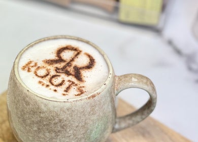 Artful latte in a textured mug at Roots & Rituals Salon Inverness, Inverness, Scotland, GB.