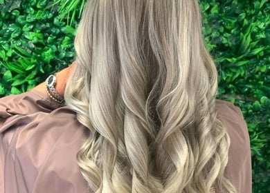 Elegant blonde curls styled at Roots & Rituals Salon Inverness, located in Inverness, Scotland, GB.