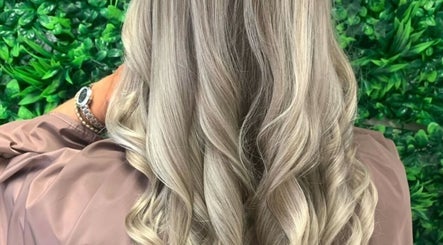 Elegant blonde curls styled at Roots & Rituals Salon Inverness, located in Inverness, Scotland, GB.