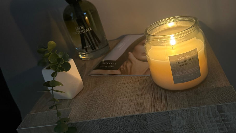 Lit candle with relaxing decor at The Head Spa Suite, Inverness, Scotland, GB.