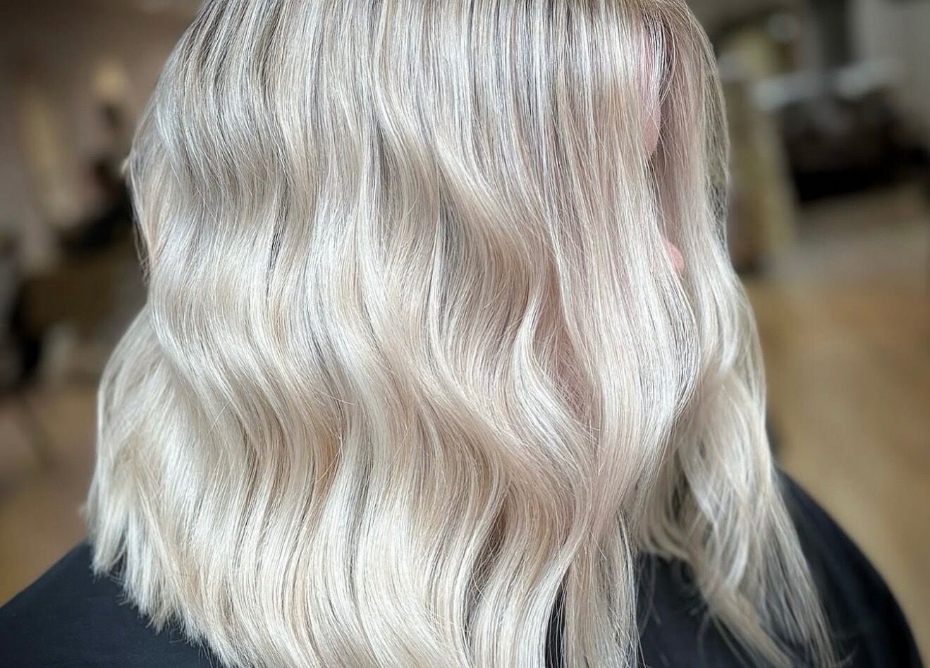 Elegant silver-blonde hair styled in waves at Roots & Rituals Salon Inverness, Scotland, GB.