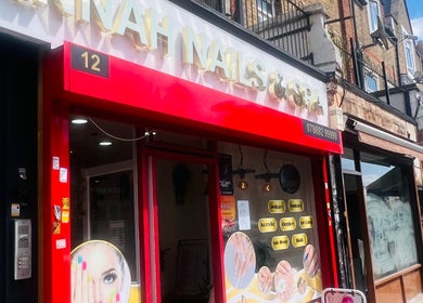Front of Glimmerbeauty in London, England, GB, featuring bright red and white signage.
