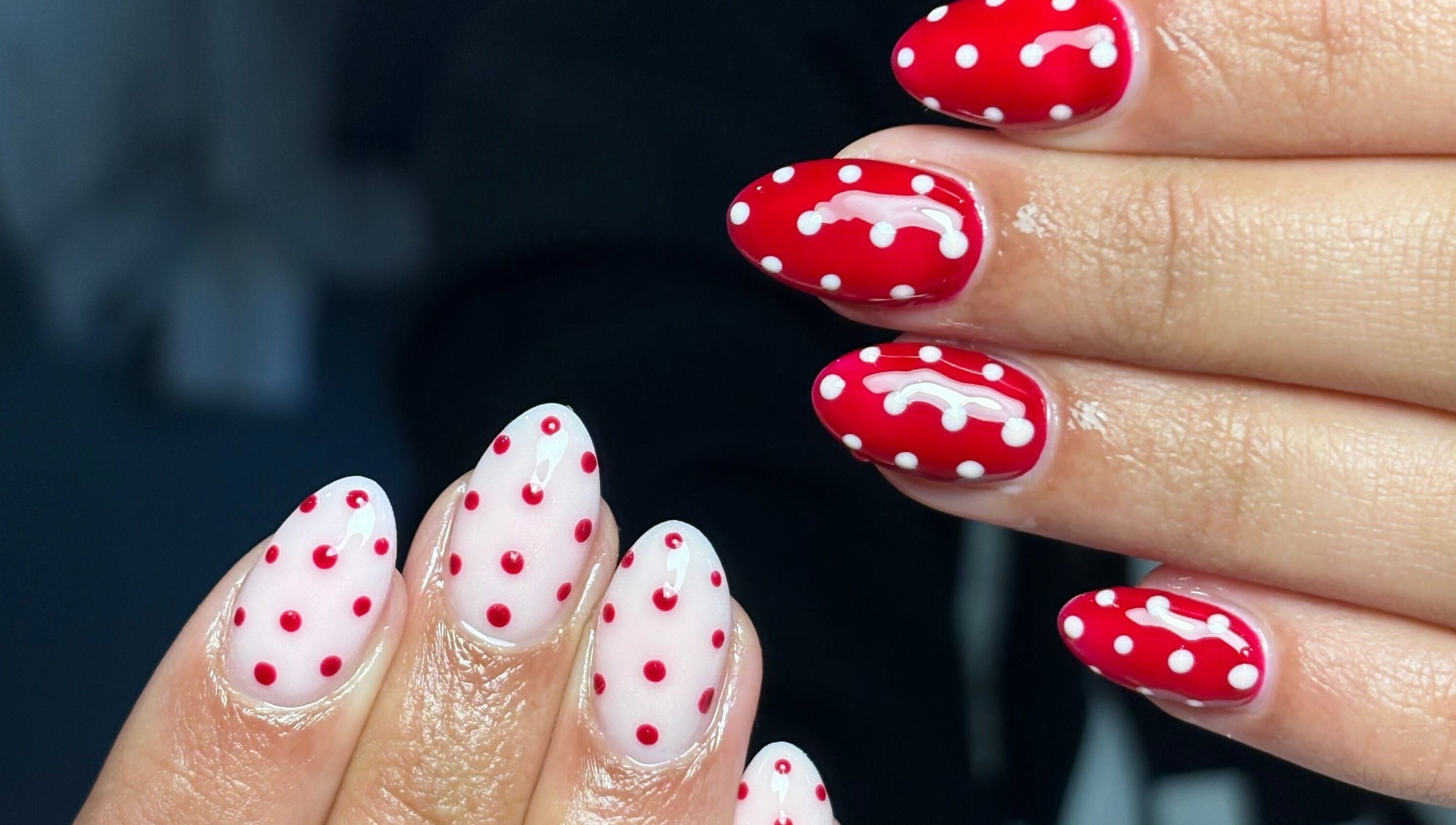 Vibrant red and white polka dot nails created at Nails by Mia in Worksop, England, GB.