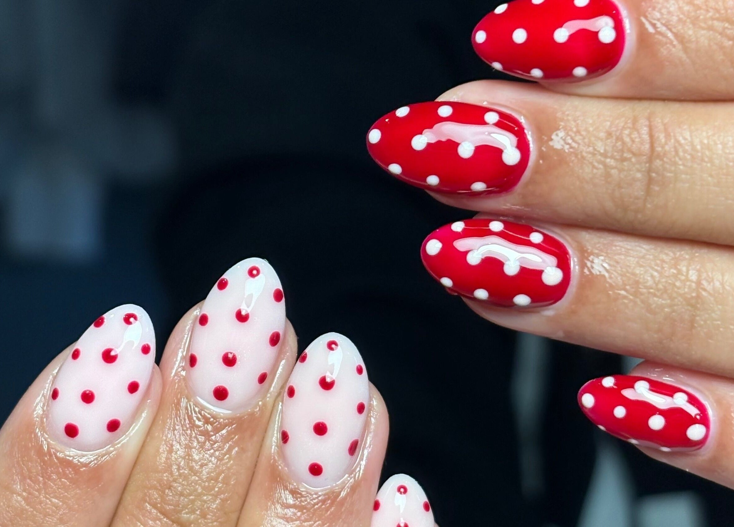Vibrant red and white polka dot nails created at Nails by Mia in Worksop, England, GB.