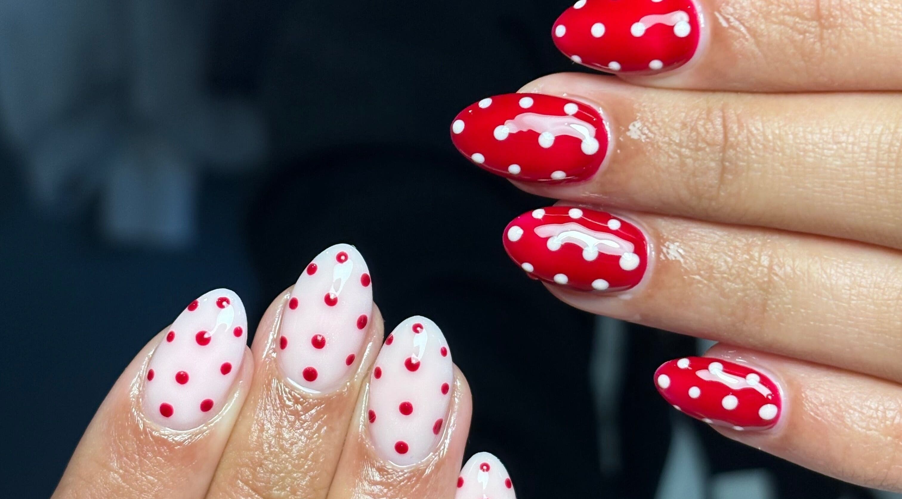 Vibrant red and white polka dot nails created at Nails by Mia in Worksop, England, GB.