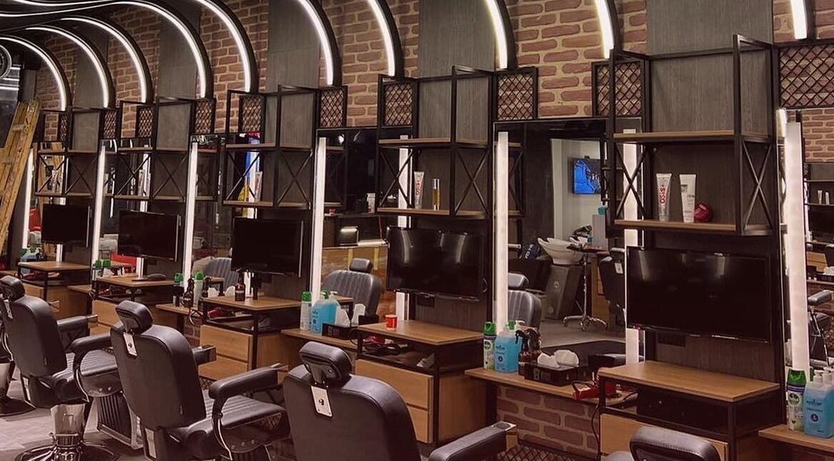 Modern barber station at Bekky Barber - The Valley, 'ud Al Bayda', Dubai, AE featuring sleek black chairs.