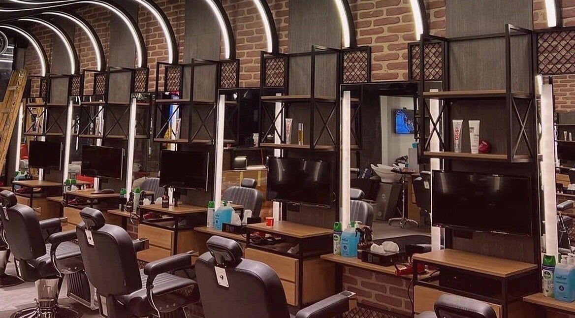 Modern barber station at Bekky Barber - The Valley, 'ud Al Bayda', Dubai, AE featuring sleek black chairs.