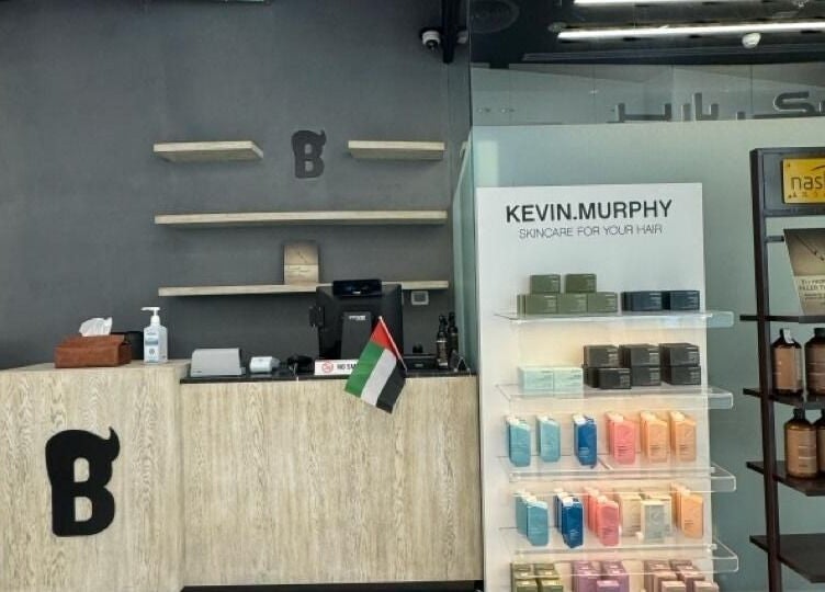 Bekky Barber - Burj Vista reception featuring product display and local flag, دبي, دبي, AE.