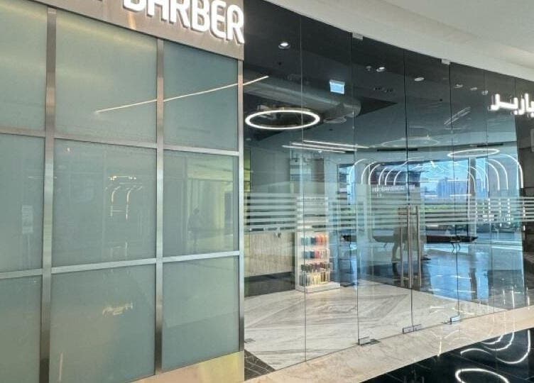 Entrance of Bekky Barber - Burj Vista, a modern salon in دبي, دبي, AE with glass doors and stylish interior.