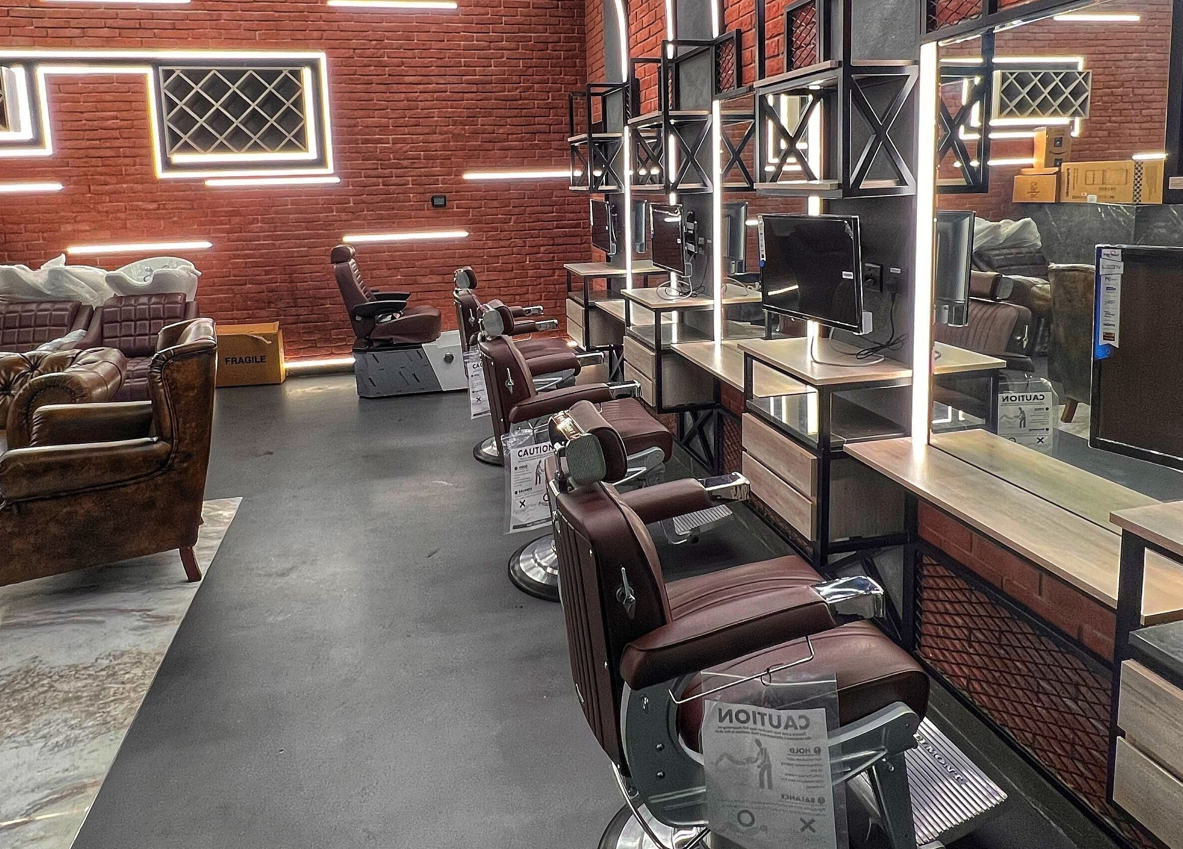 Modern barber setup at Bekky Barber - Beach Front, Dubai, AE with sleek leather chairs and illuminated mirrors.