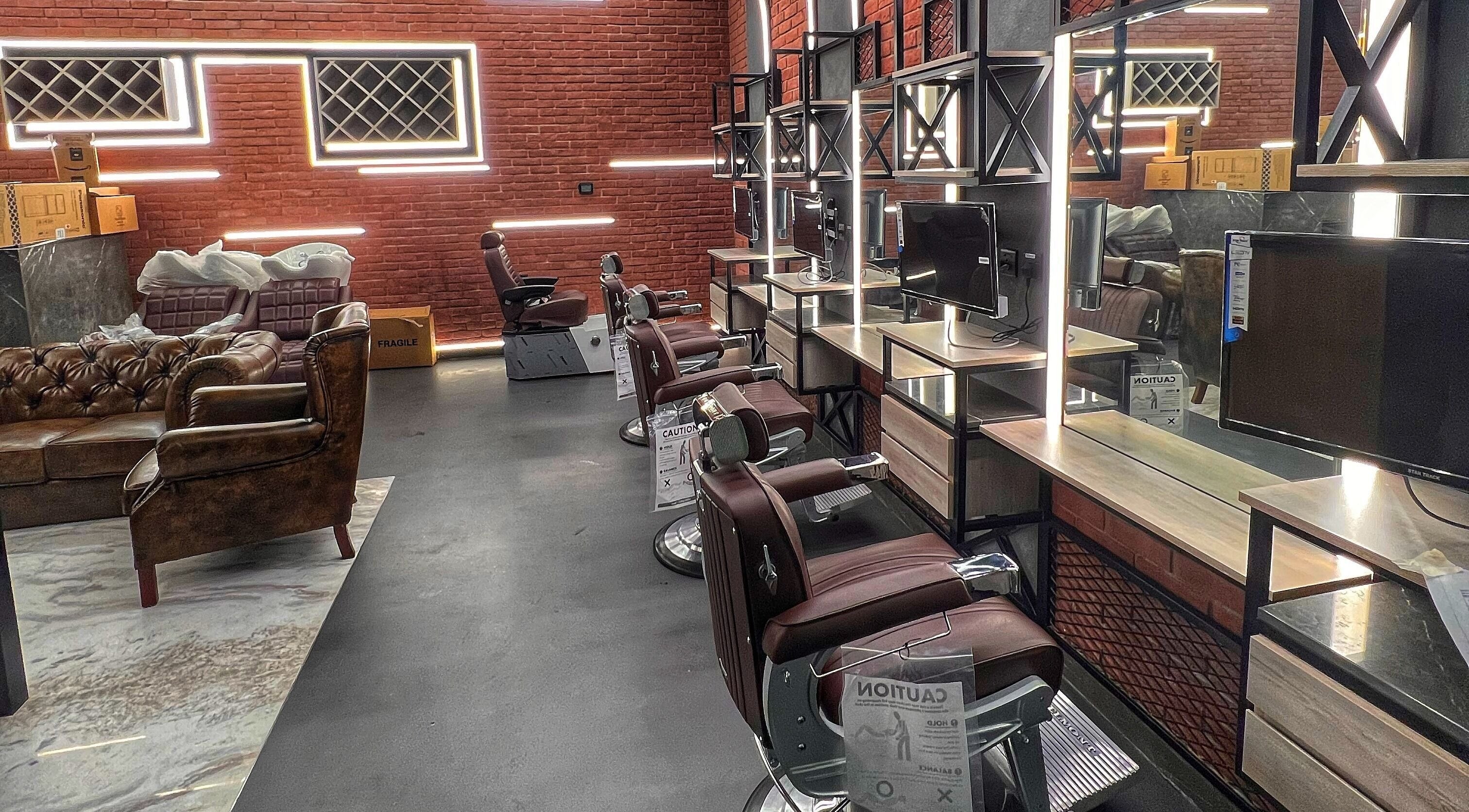 Modern barber setup at Bekky Barber - Beach Front, Dubai, AE with sleek leather chairs and illuminated mirrors.