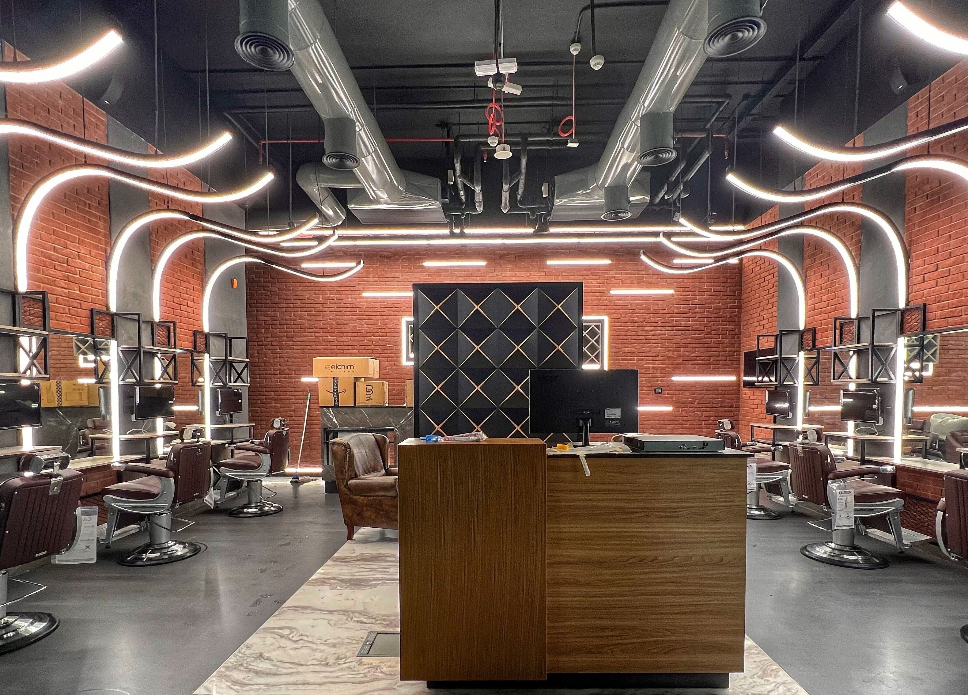 Modern interior of Bekky Barber - Beach Front in Dubai, AE, showcasing sleek, well-lit barber stations.