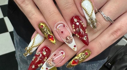 Intricate nail art design at Fitzroy - Mitty Nails & Beauty, Melbourne, Victoria, AU with gold and red embellishments.