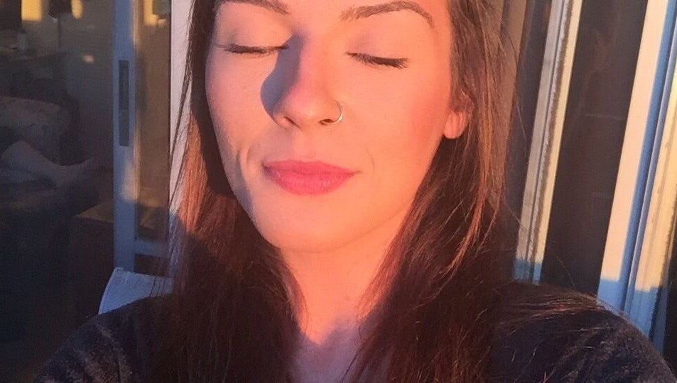 Woman basks in golden sunlight at Good Juju Holistic, Melbourne, Victoria, AU, promoting wellness and peace.