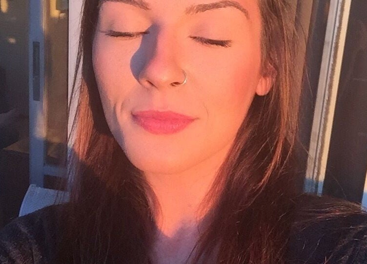 Woman basks in golden sunlight at Good Juju Holistic, Melbourne, Victoria, AU, promoting wellness and peace.