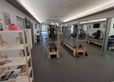 Therapy room at Thai Fusion Remedial Massage in Southport, Queensland, AU, with Pilates equipment and serene ambiance.