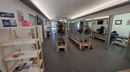 Therapy room at Thai Fusion Remedial Massage in Southport, Queensland, AU, with Pilates equipment and serene ambiance.