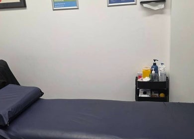 Cozy massage room at Thai Fusion Remedial Massage in Southport, Queensland, AU with treatment table and supplies.