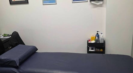 Cozy massage room at Thai Fusion Remedial Massage in Southport, Queensland, AU with treatment table and supplies.