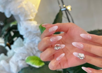 Elegant nail art with embellishments at Nail Monster, Brookline, Massachusetts, US.