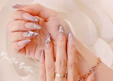 Elegant nail art with rhinestones at Nail Monster, Brookline, Massachusetts, US.