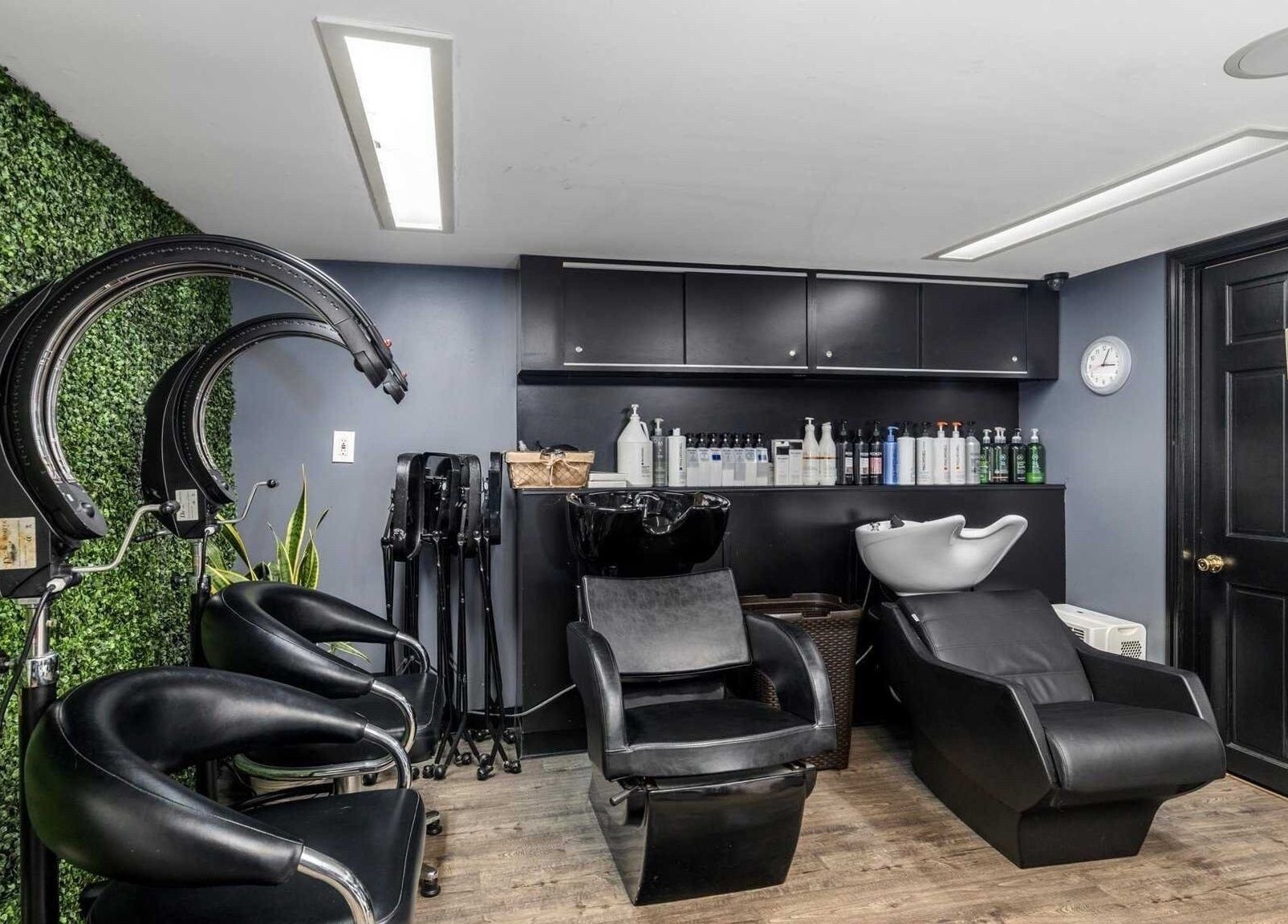 Elegant hair salon setup at Michele's Station Square Hair Salon, Rutherford, New Jersey, US with modern chairs and greenery.