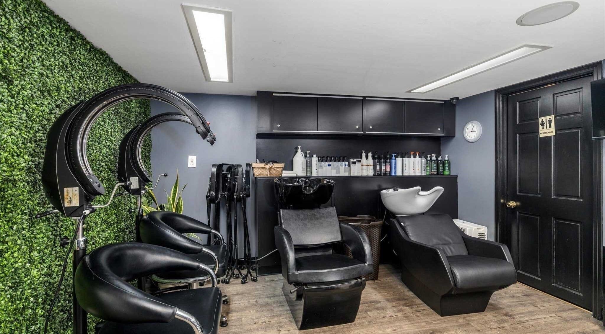 Elegant hair salon setup at Michele's Station Square Hair Salon, Rutherford, New Jersey, US with modern chairs and greenery.