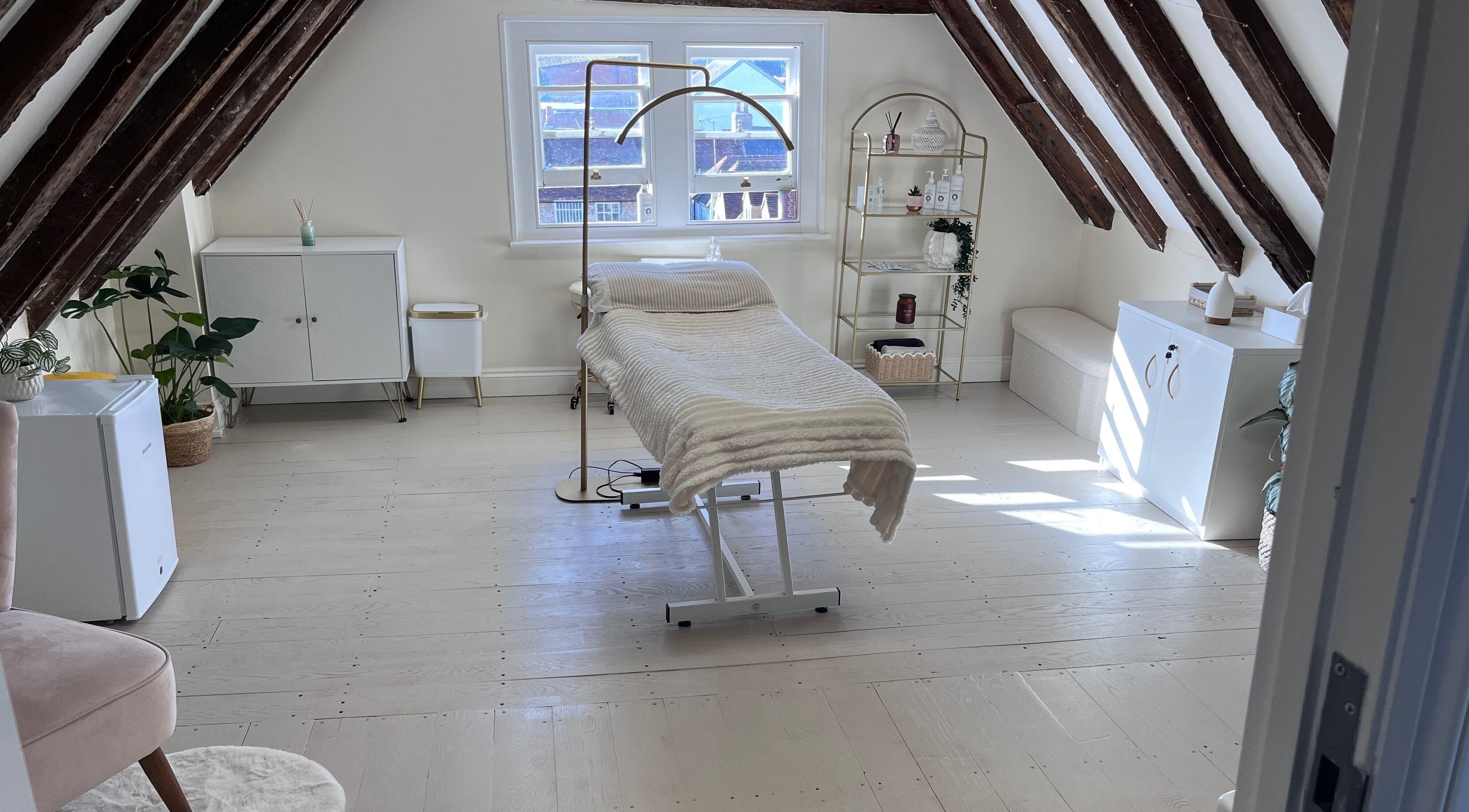 Peaceful treatment room at FX Aesthetics and Beauty, Chichester, England, GB with warm decor and natural light.