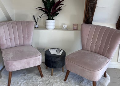 Chic seating area at FX Aesthetics and Beauty in Chichester, England, GB with plush pink chairs and decor.