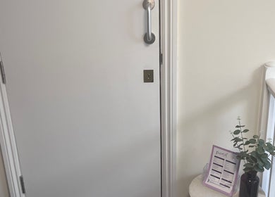 Entrance at FX Aesthetics and Beauty, Chichester, England with decor and price list.