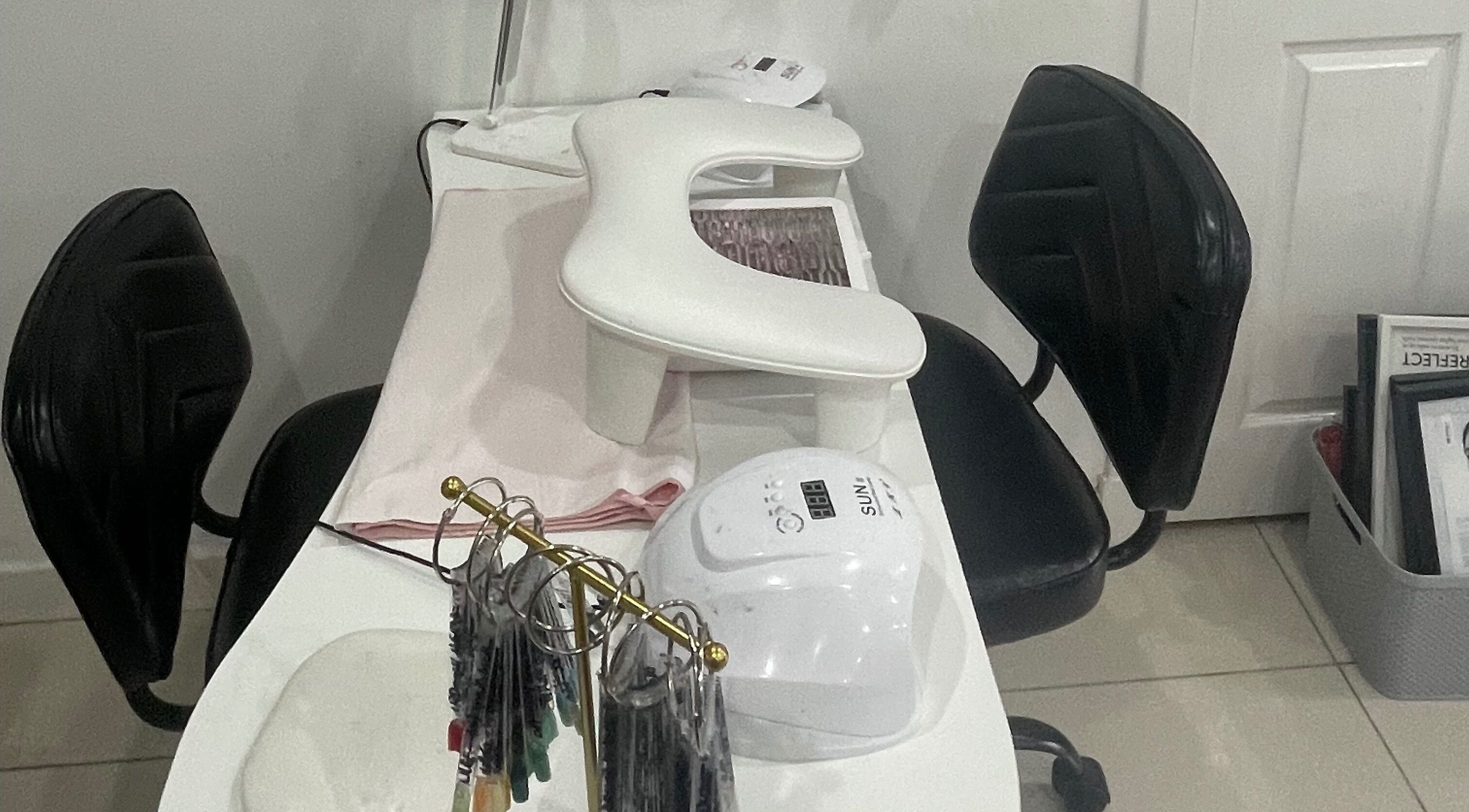 Professional nail station at S.L.W pro education in Glasgow, Scotland, GB, equipped with modern tools and seating.