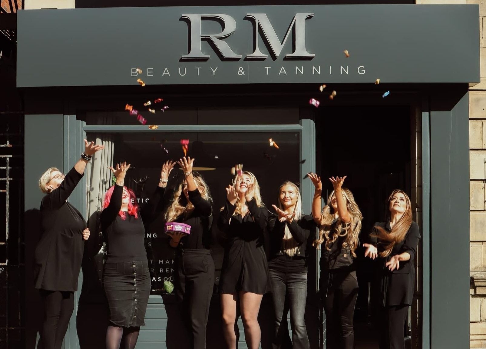 Team celebration at Glowmeup, Rochdale, England, GB highlighting beauty and wellness services.