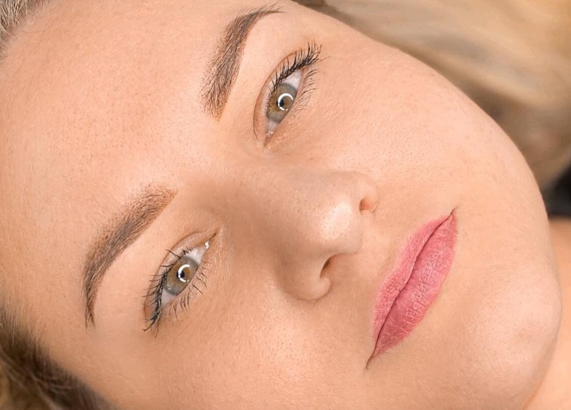 Close-up of a woman's serene face showcasing beauty treatment results at Glowmeup in Rochdale, England, GB.