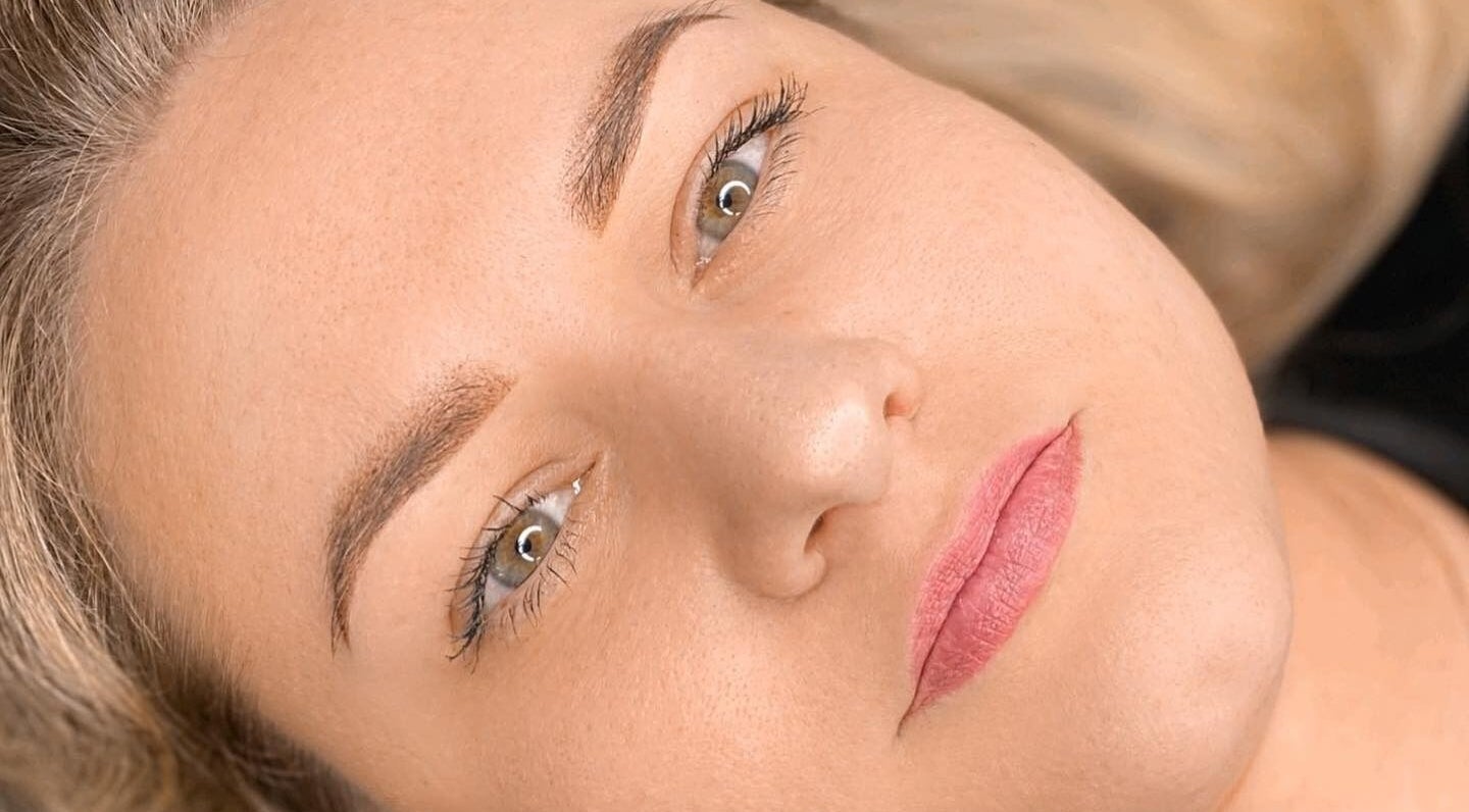 Close-up of a woman's serene face showcasing beauty treatment results at Glowmeup in Rochdale, England, GB.