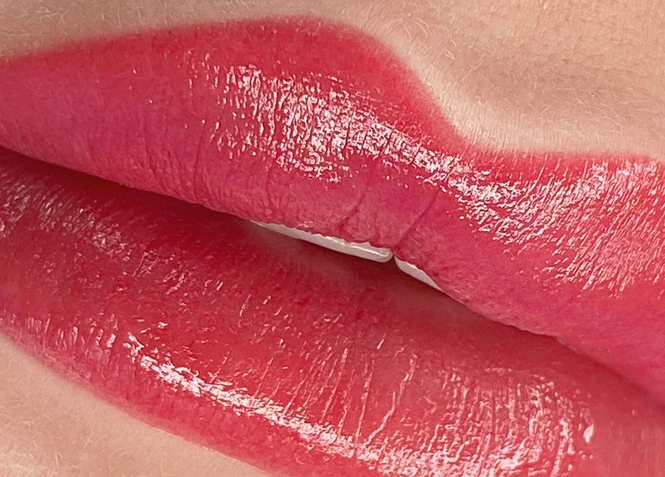 Bold red lips showcasing a vibrant gloss at Glowmeup, Rochdale, England, GB.