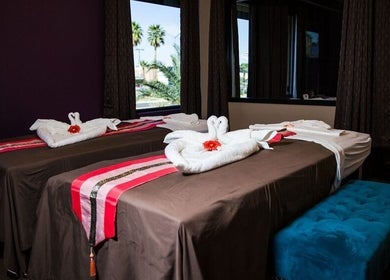 Relaxing massage tables at Sawasdee Thai Spa in Las Vegas, Nevada, US with elegant towel decorations and calming decor.
