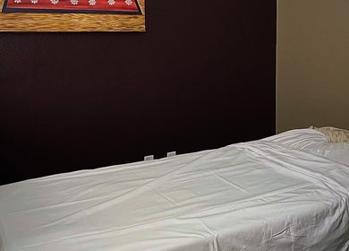 Relaxing massage room at Sawasdee Thai Spa, Las Vegas, Nevada, US, with a cozy bed and calming decor.