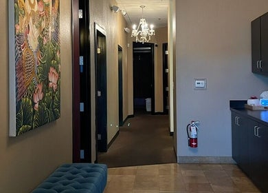 Elegant corridor at Sawasdee Thai Spa in Las Vegas, Nevada, US with chandelier and Thai artwork.