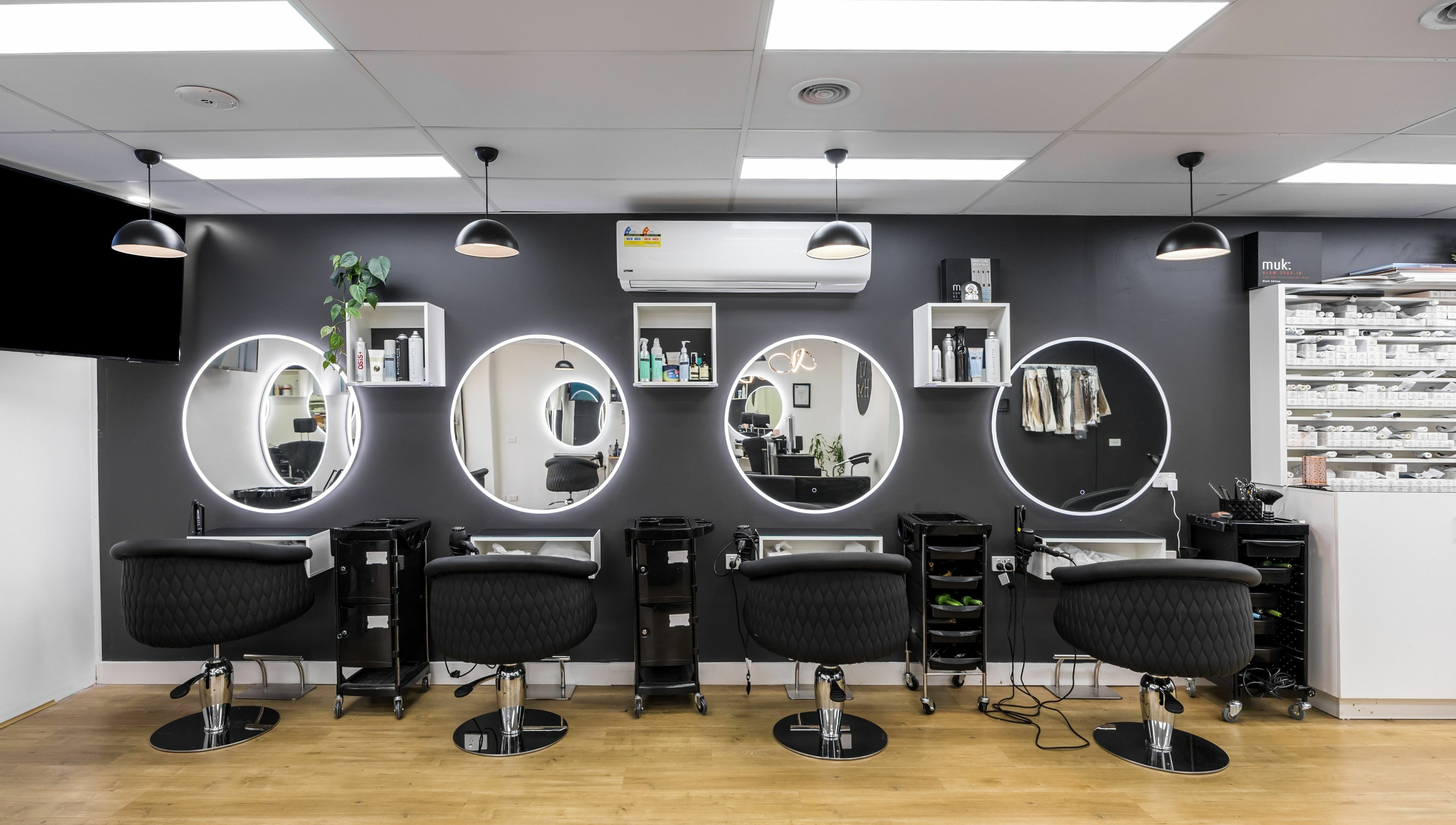 Chic salon stations with round mirrors at V.I Hair, Melbourne, Victoria, AU, ready for stylish transformations.