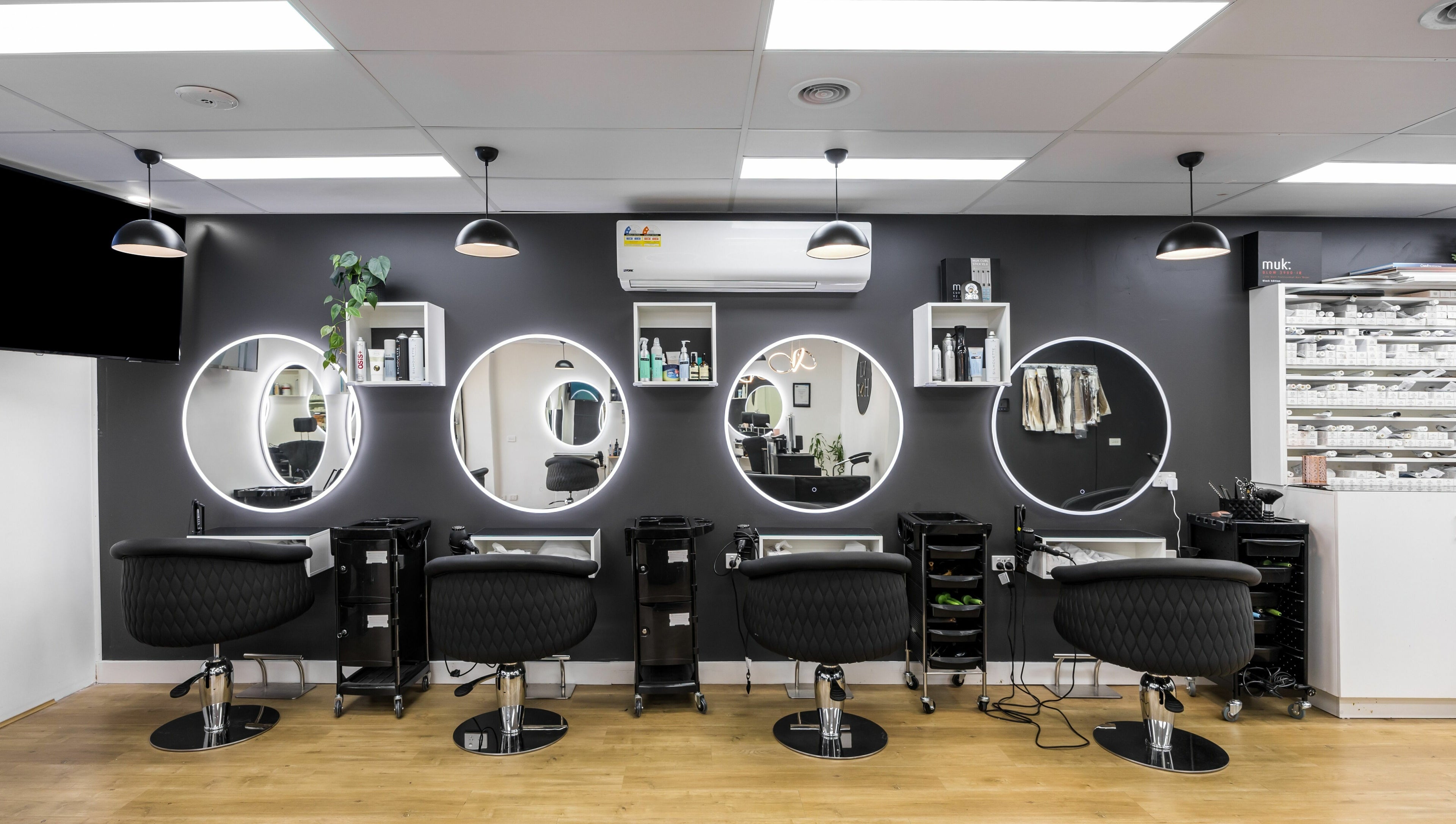Chic salon stations with round mirrors at V.I Hair, Melbourne, Victoria, AU, ready for stylish transformations.