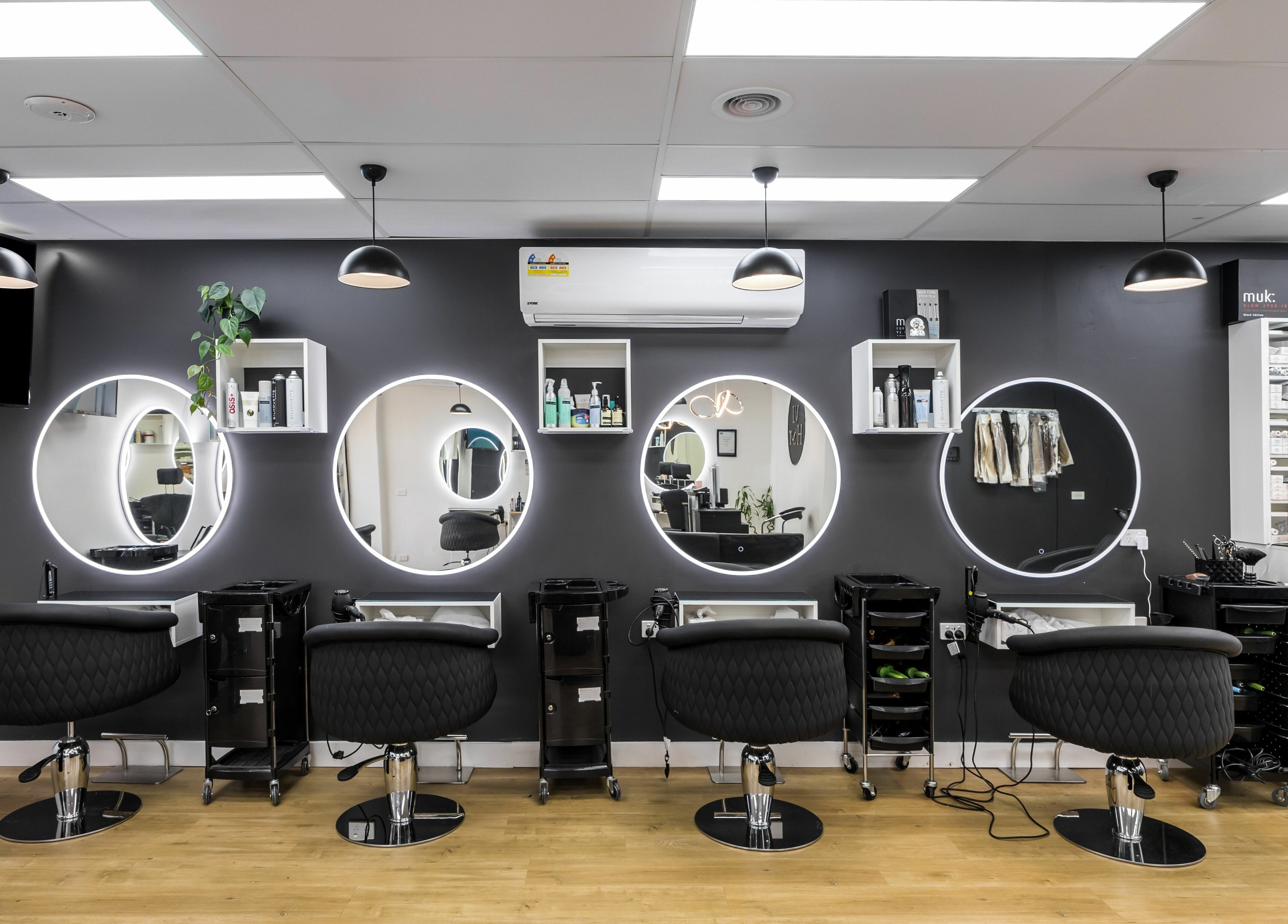 Chic salon stations with round mirrors at V.I Hair, Melbourne, Victoria, AU, ready for stylish transformations.