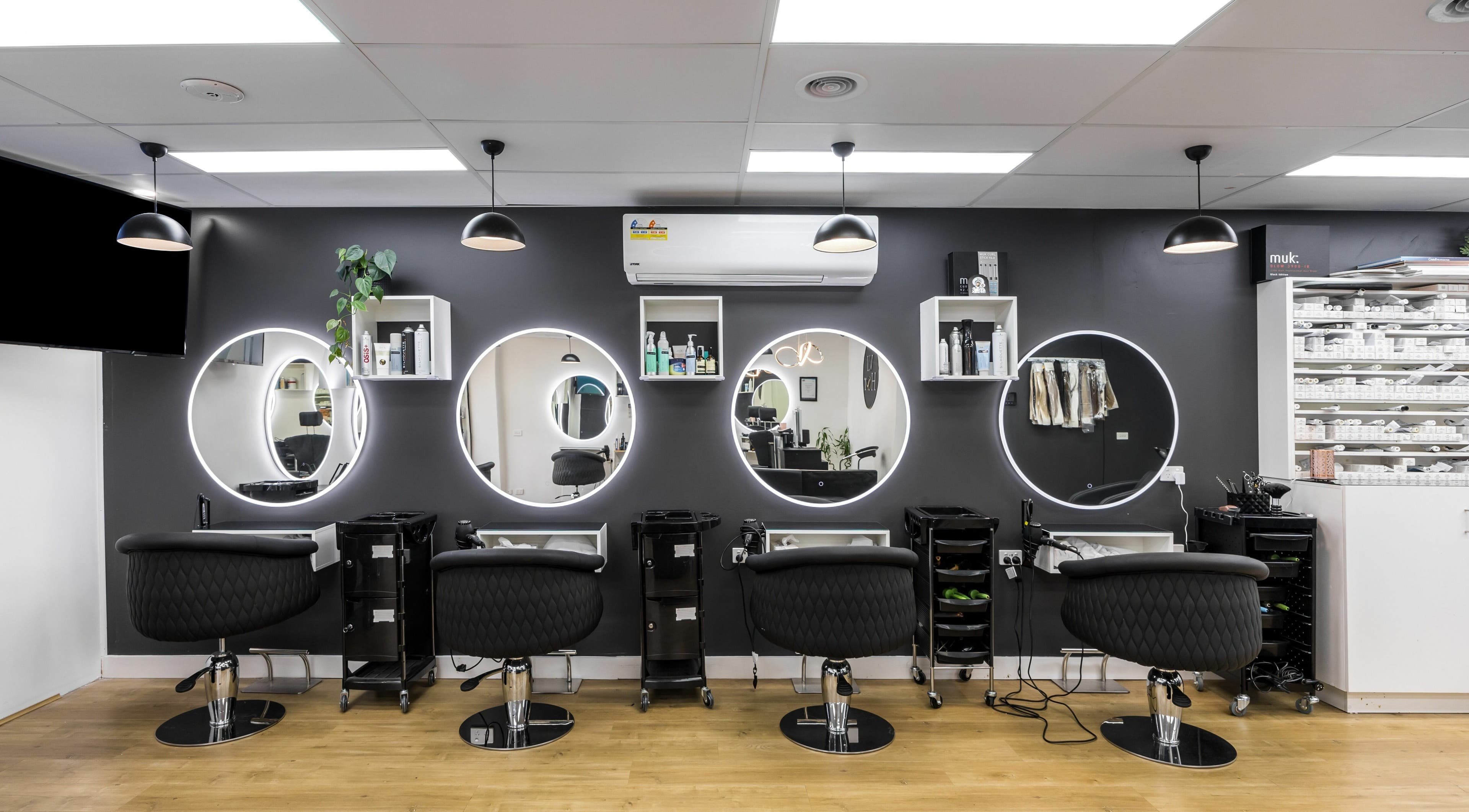 Chic salon stations with round mirrors at V.I Hair, Melbourne, Victoria, AU, ready for stylish transformations.