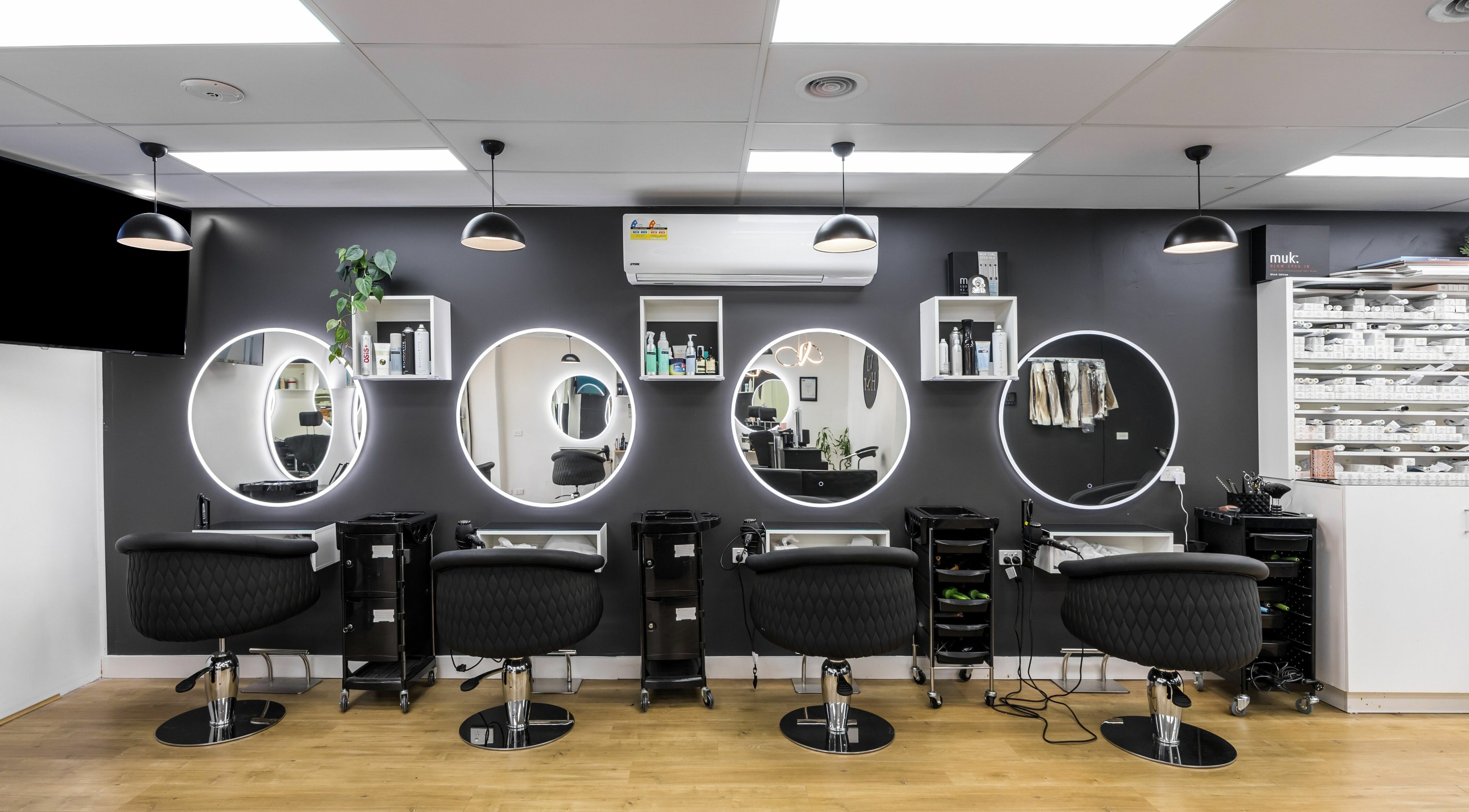 Chic salon stations with round mirrors at V.I Hair, Melbourne, Victoria, AU, ready for stylish transformations.
