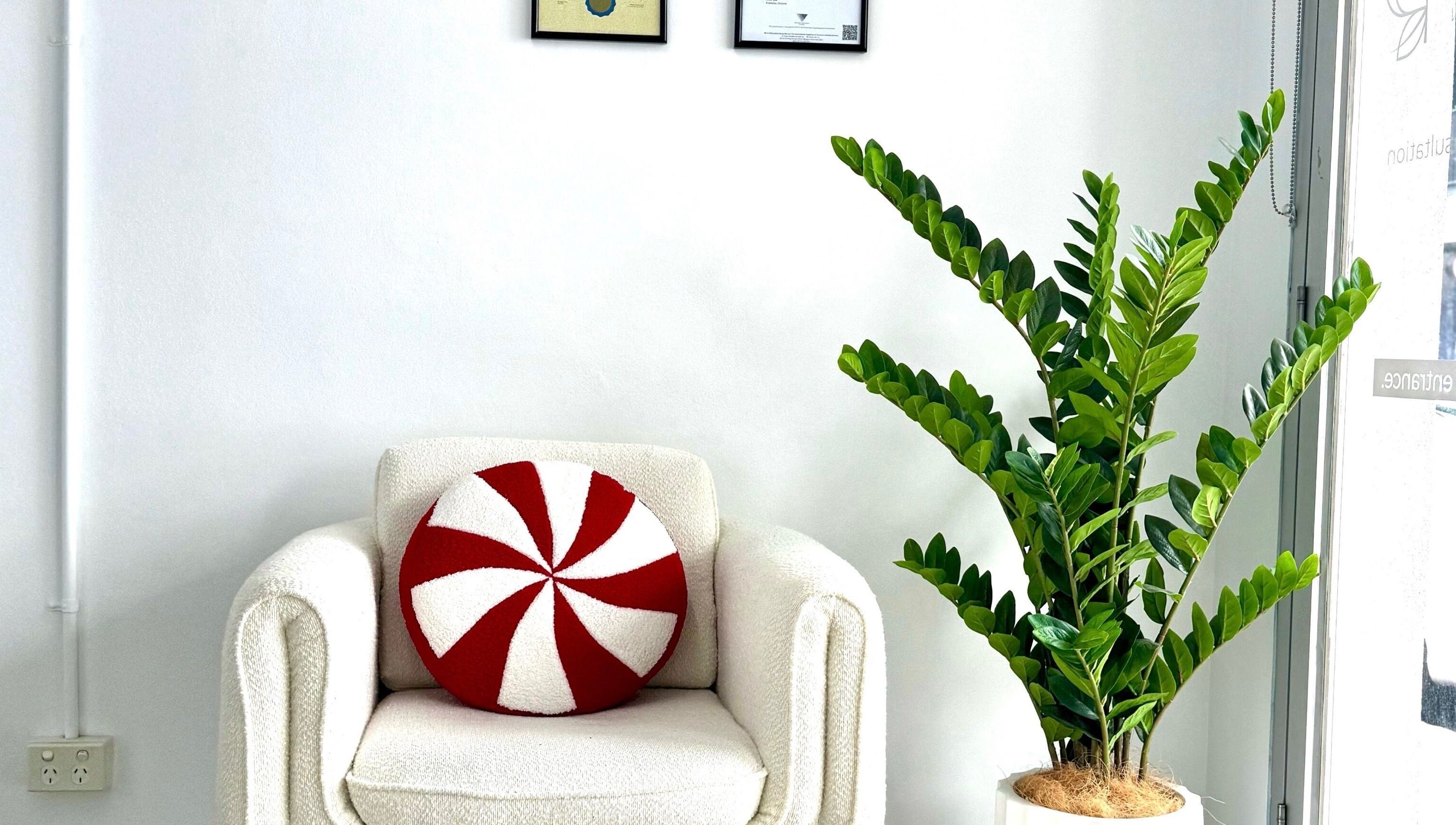 Inviting chair with red pillow at Rejuvenate Hair and Skin, Moonee Ponds, Victoria, AU.